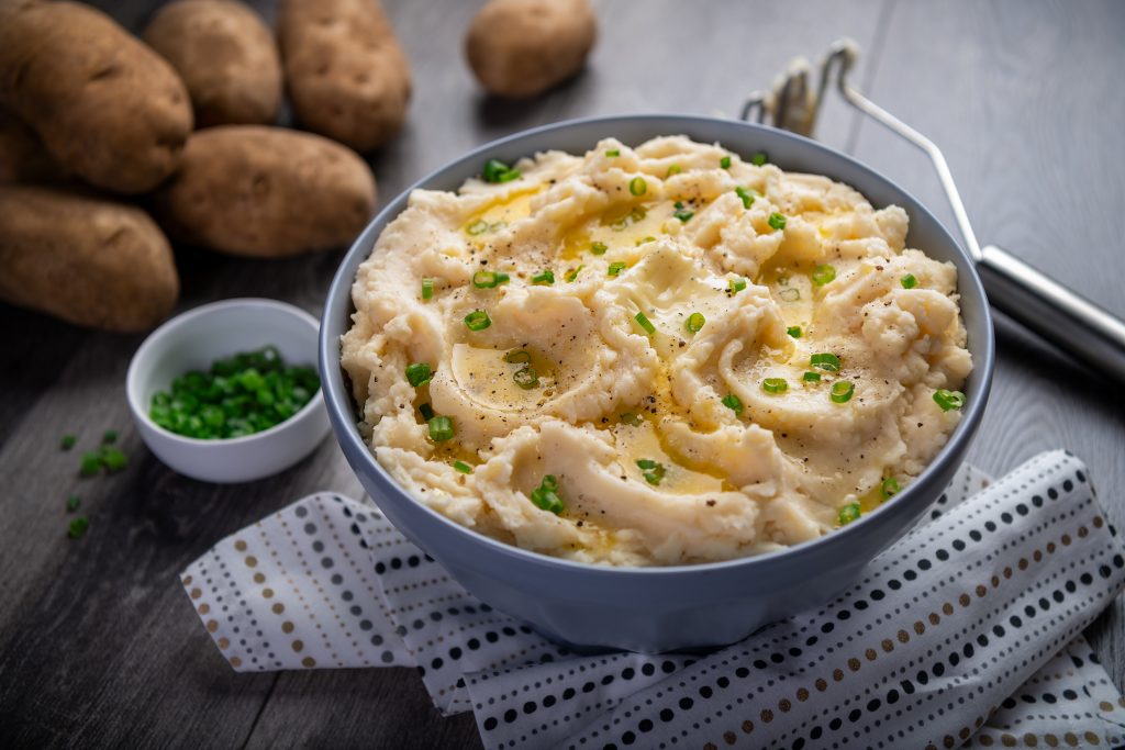 mashed potatoes drenched in butter with some green chilies