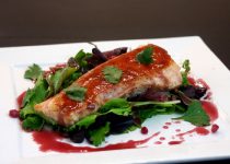 Pan Seared Salmon with Pomegranate Reduction served